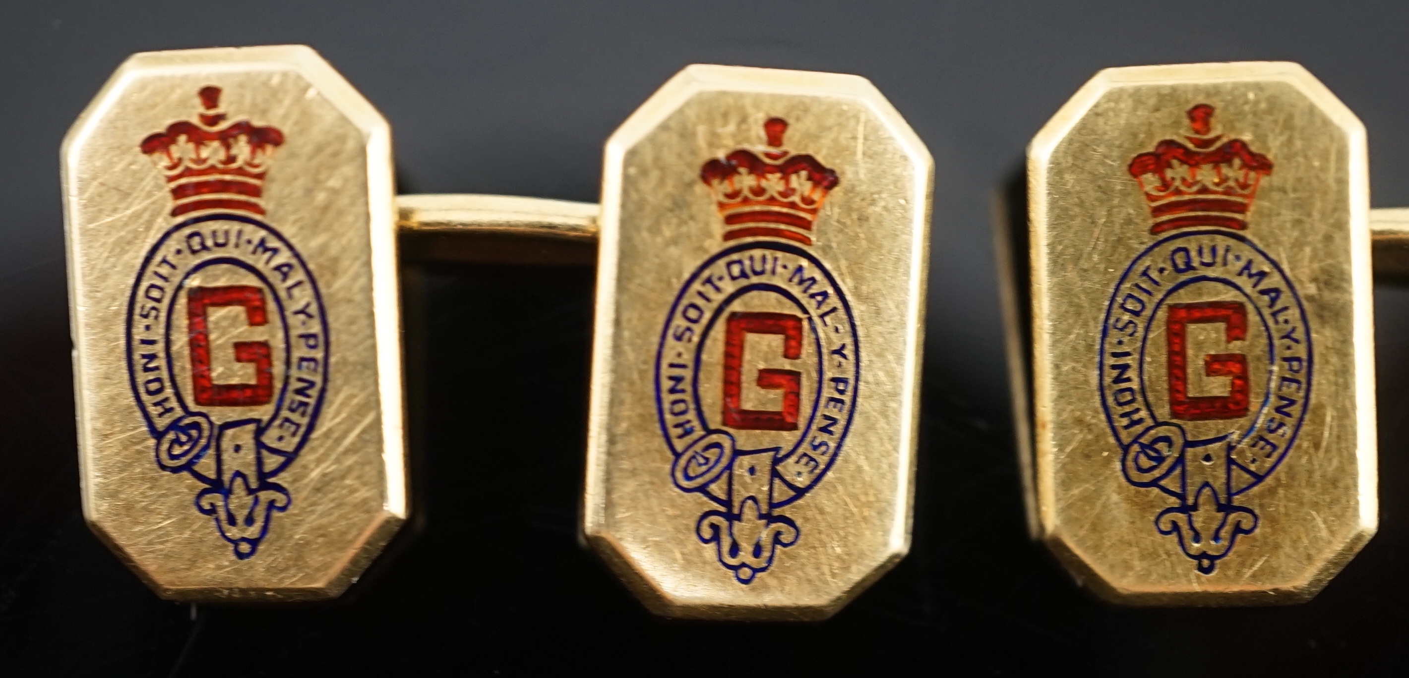 A pair of 1920's/1930's Cartier gold and two colour enamel rectangular Regimental cufflinks, with canted corners